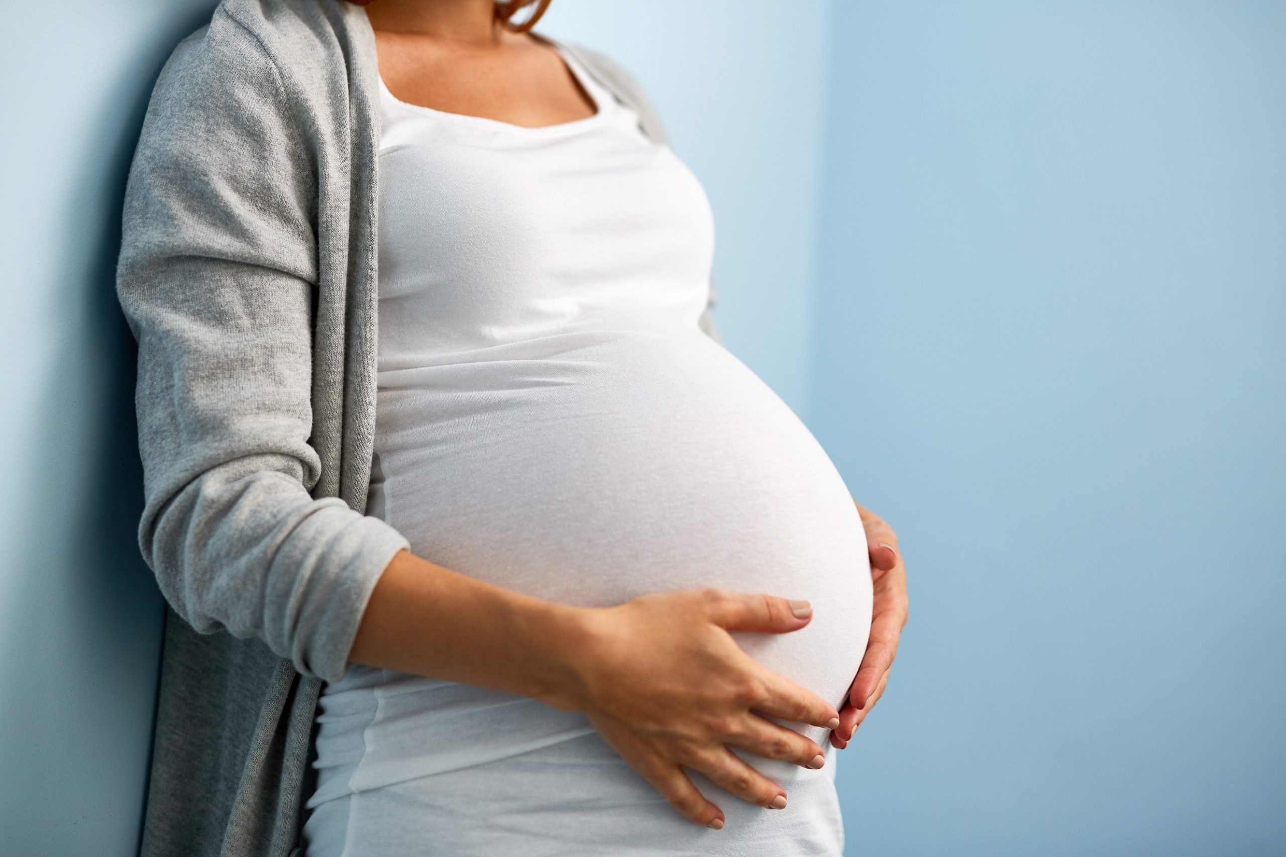 Pregnant woman cradling her belly