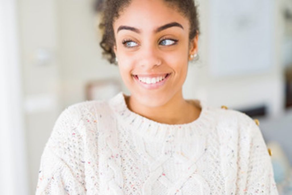 person will nice smile enjoying cosmetic benefits of dental implants