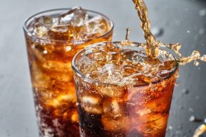 Two glasses of iced soda.
